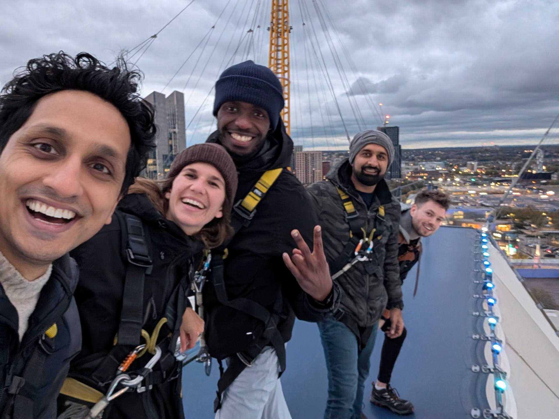 Team climb over the O2 Arena at dusk